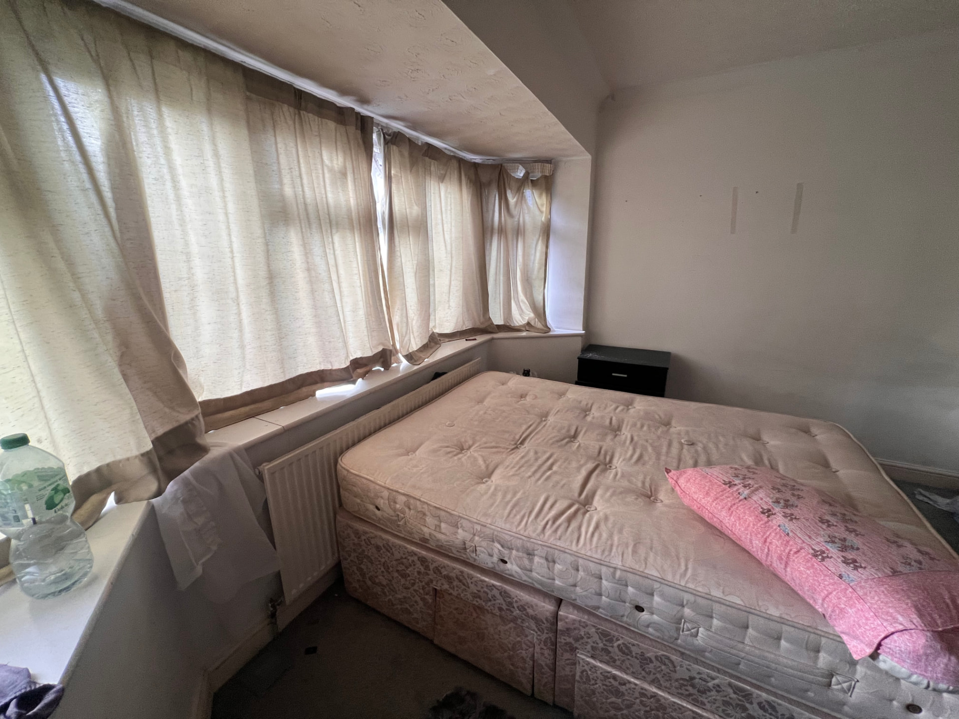 Dated bedroom with old mattress before renovation