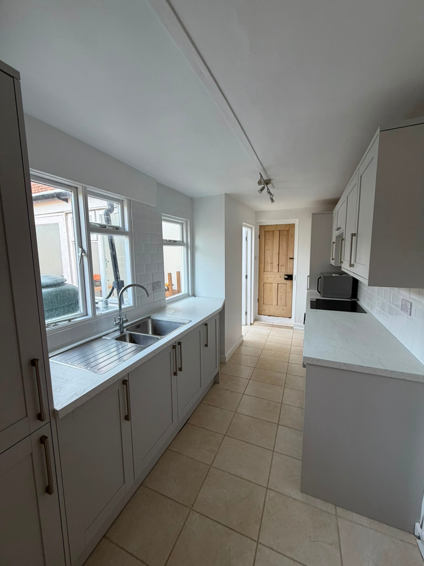 Modern grey galley kitchen after refurbishment by RedFox Homes